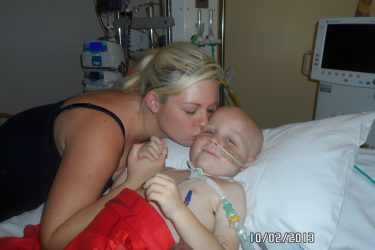 Mum Llian kisses Blake in his hospital bed