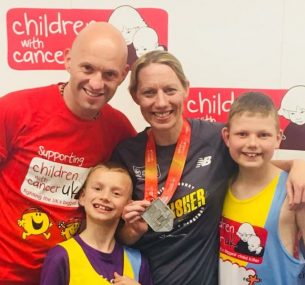 lady with medal with three people