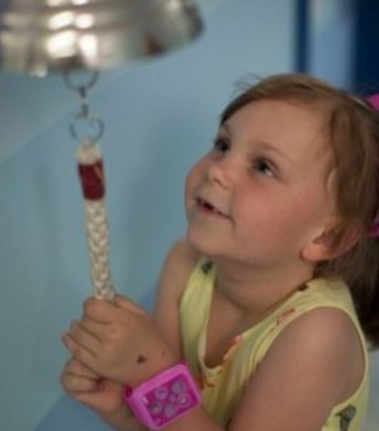 Olivia ringing the end of treatment bell