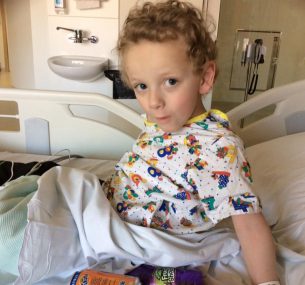 boy sitting on bed