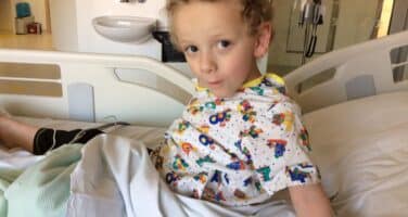 boy sitting on bed