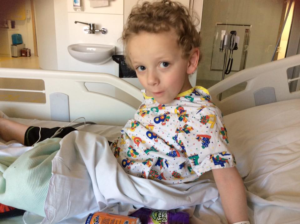 boy sitting on bed