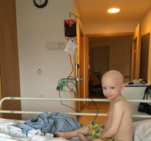 boy sitting on the bed having blood