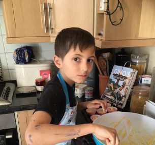 Boy in apron and mixing bowl