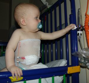 baby in a cot in hospital