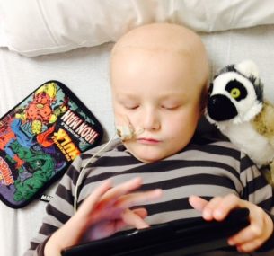 Henry boy with pencil case and teddy in bed