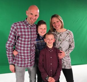 Family in front of green screen