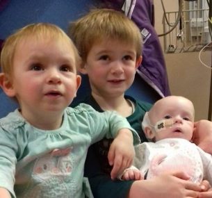 Lucie in hospital with siblings