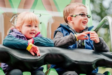 Little boy and girl having fun on a ride