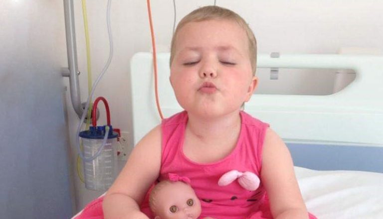 girl in pink dress in hospital