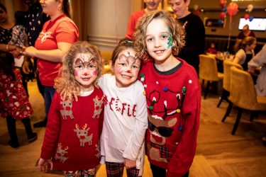 Children with face paint at the London Christmas party