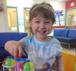 Girl with colourful plastic toy in hospital