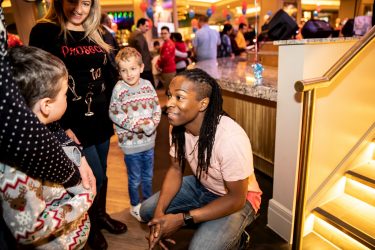 Nigel Clarke talking to a child at the London Christmas party