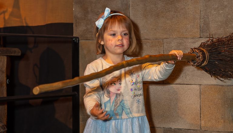 Sophia Bird with broomstick at Warner Bros studio tour