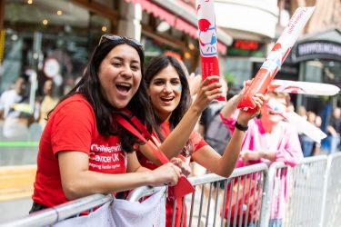 two people cheering at ASICS 10k run in london