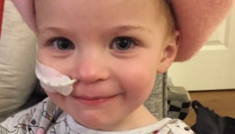 Alice wearing a pink beret after being diagnosed with neuroblastoma