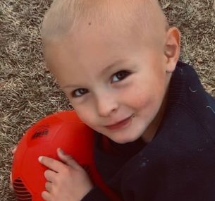 Boy with red football