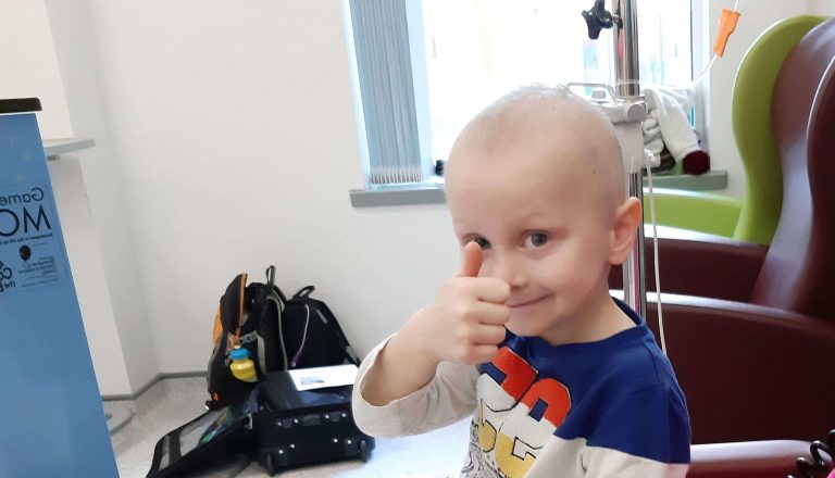 Ceylian boy smiling with thumbs up in hospital