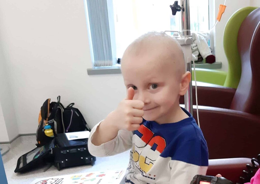 Ceylian boy smiling with thumbs up in hospital