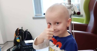 Ceylian boy smiling with thumbs up in hospital