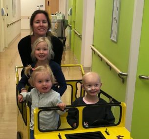 Children in yellow car in hospital