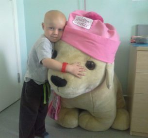 Ollie in hospital hugging a cuddly toy
