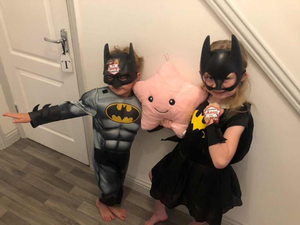 Evie and Tommy dressed as batman and batwoman