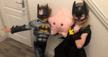 Evie and Tommy dressed as batman and batwoman