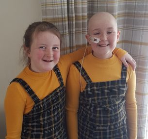 Two girls in matching dresses