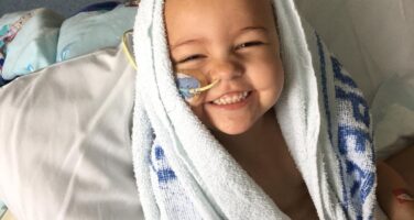Girl with feeding tube in towel