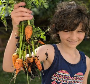 Girl holding carrots