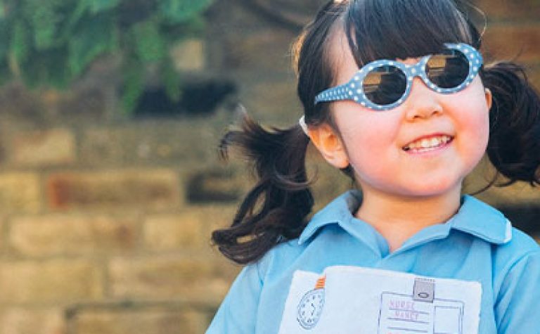 Astrid smiling and wearing her sunglasses