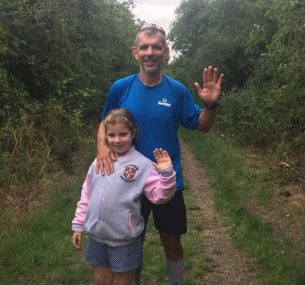 Adam at finish line smiling with daughter