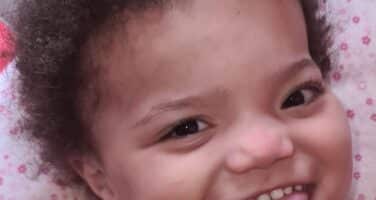 baby girl smiling with her tongue out