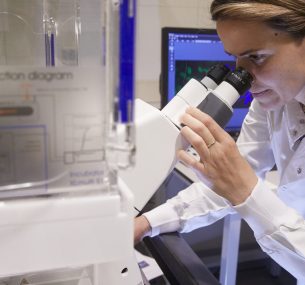 Cancer treatments being tested in a laboratory by a female researcher