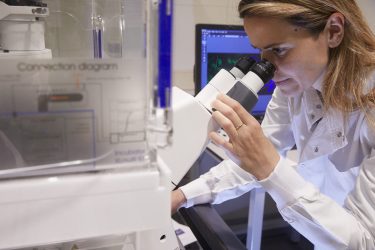 Cancer treatments being tested in a laboratory by a female researcher