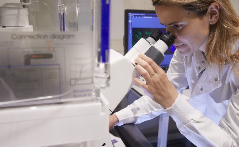 Cancer treatments being tested in a laboratory by a female researcher