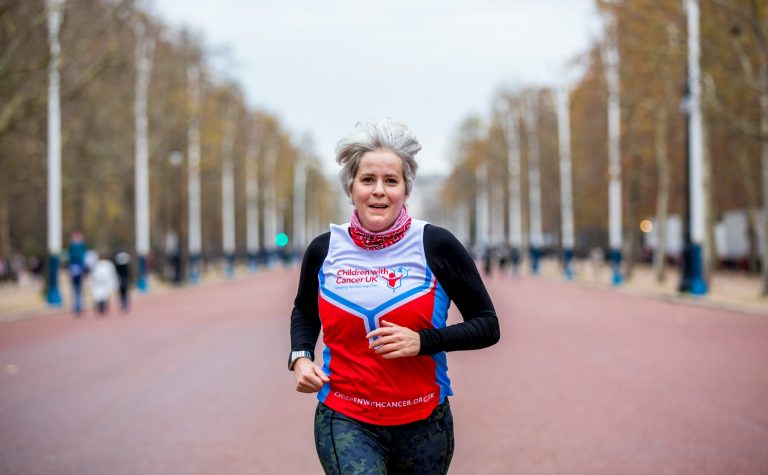 Children with Cancer UK runner running on her own