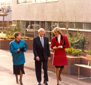 Princess Diana walking wearing a red coat with Marion and Eddie OGorman