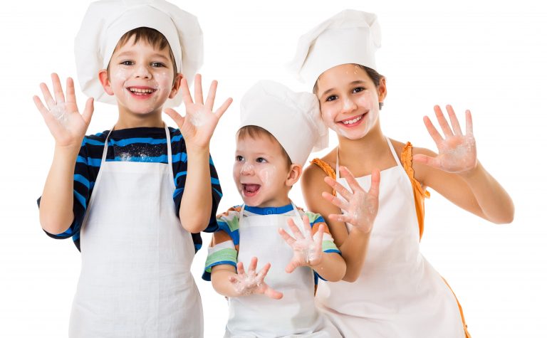 Children Baking wearing white chef hats and apron