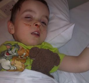 Harry asleep with teddy after being diagnosed