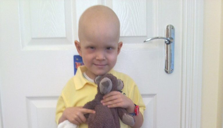 Harry on his First Day Of School in a yellow tshirt holding teddy 1