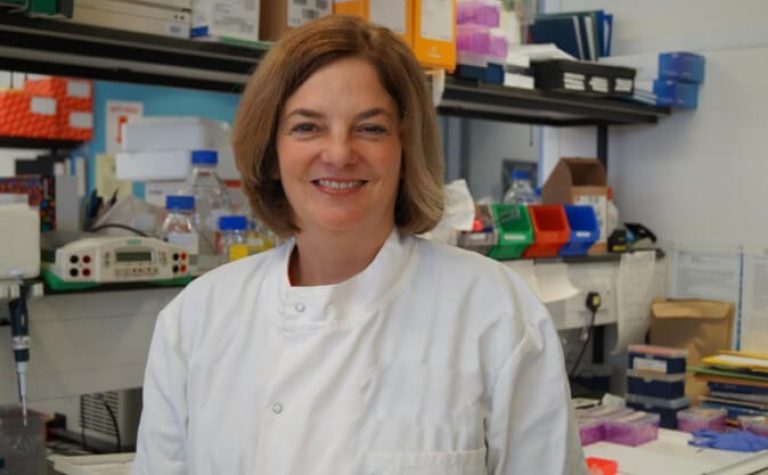 julie irving female researcher wearing white lab coat