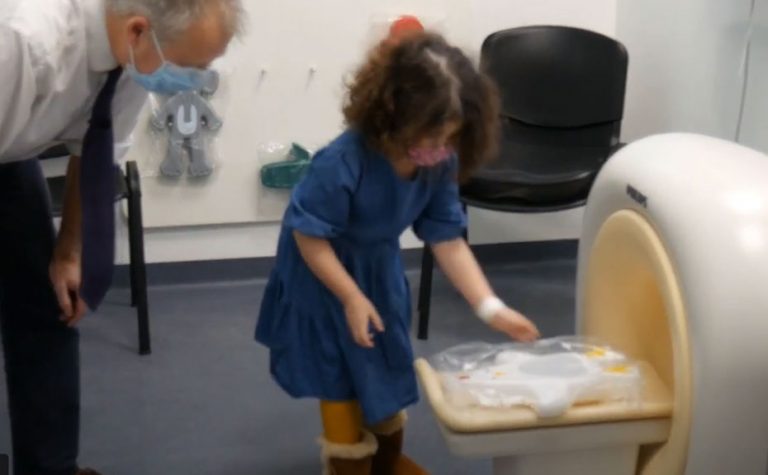 Child scanning a toy in model of the MRI scanner