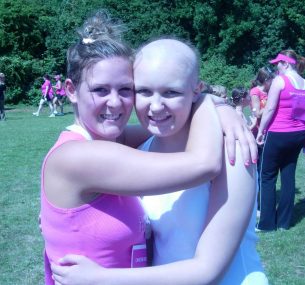 chloe with no hair hugging friend