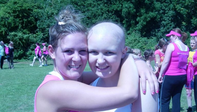 chloe with no hair hugging friend