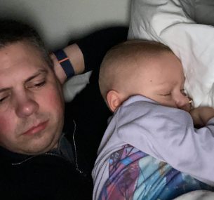 Isla and dad lying in hopsital bed July 2021..