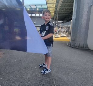 Finely at the stadium wearing footbal shirt