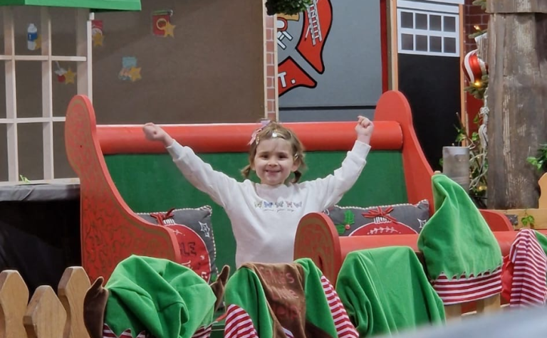 Isabellah arms up in santas sleigh v2