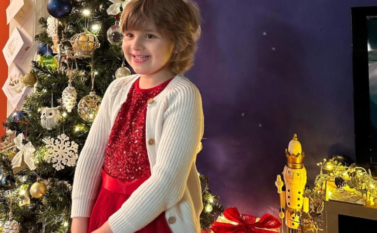 Isabellah smiling in front of Xmas tree V2